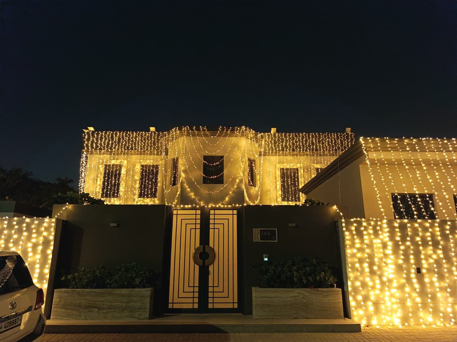 Home modern wedding entrance lighting in qatar with decorative led lights enhancing the gate and exterior walls of a private residence