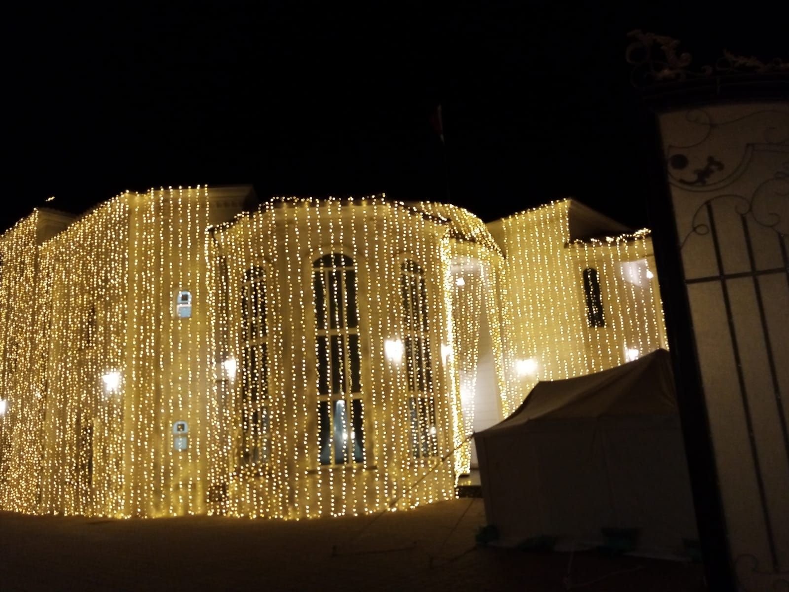 Home professional wedding lighting installation in qatar highlighting a large villa with curtain style led lights for an evening celebration