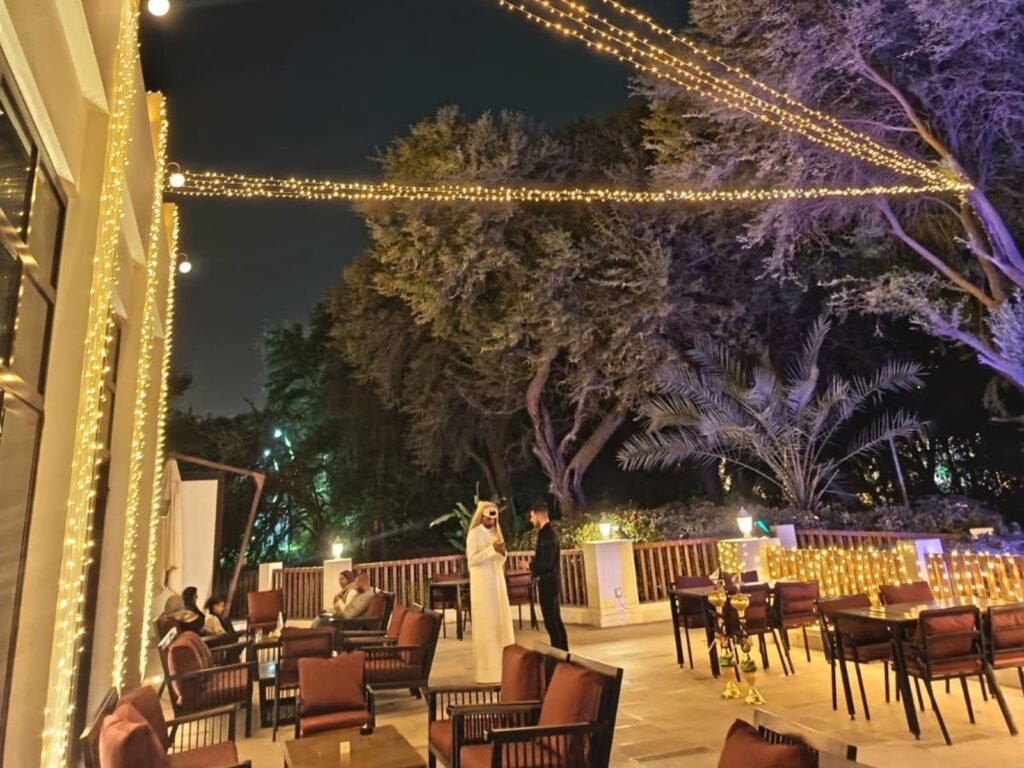 garden event lighting with warm white fairy lights wrapped around railings and trees